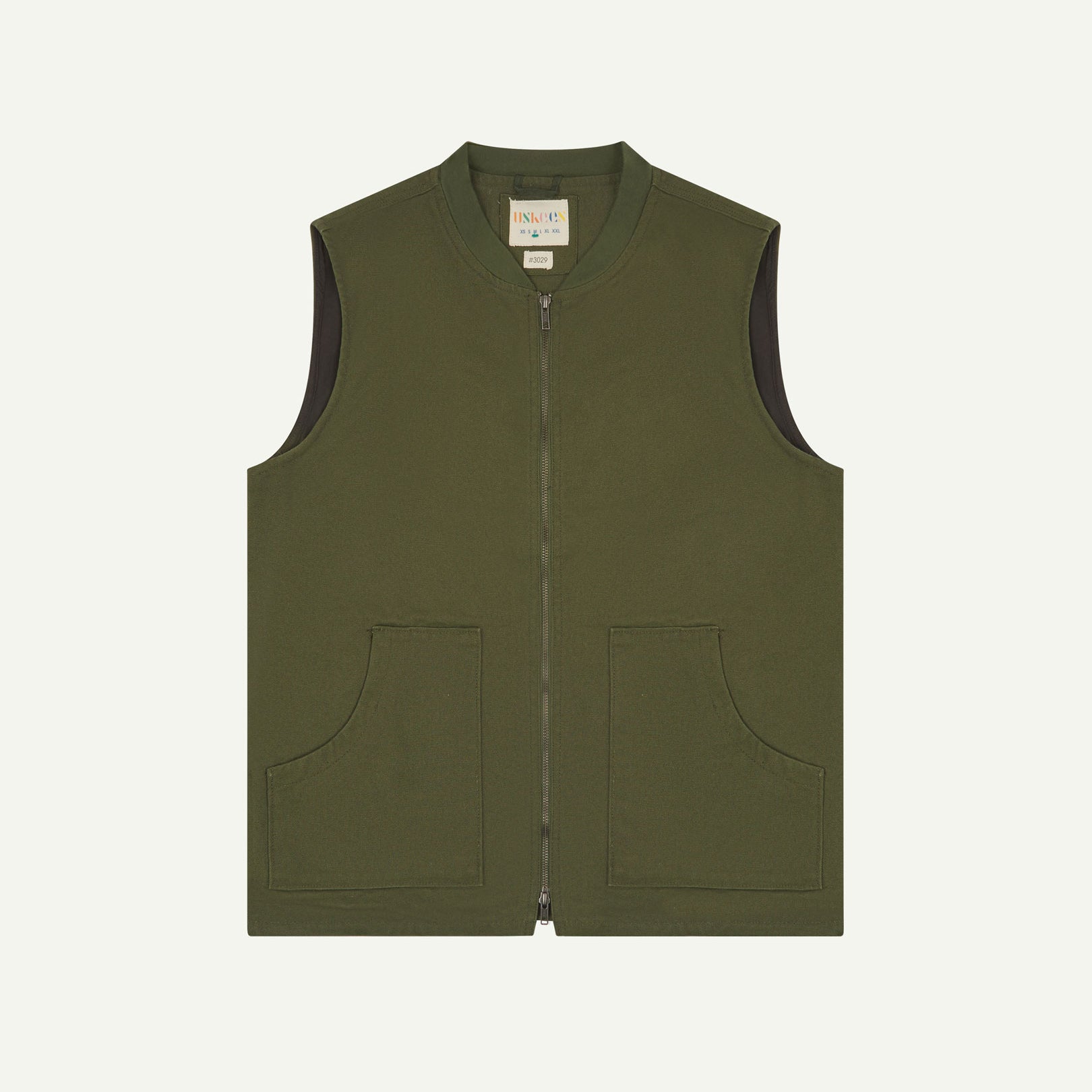 Front flat shot of Uskees coriander green gilet-type zip front waistcoat showing the front patch pockets and inner brand label at neck.