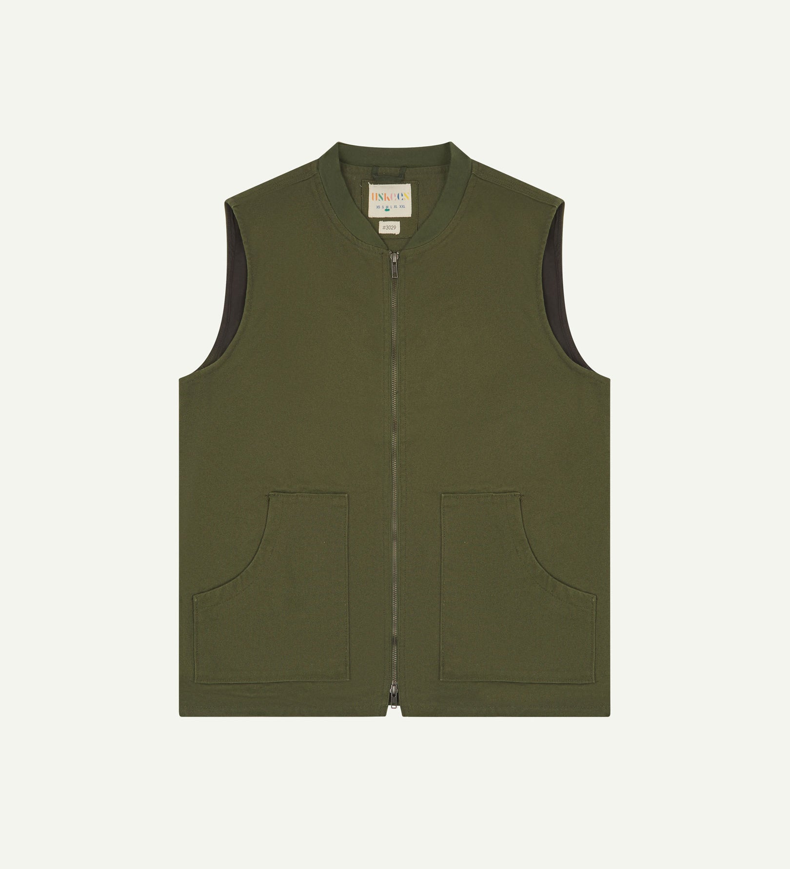 Front flat shot of Uskees coriander green gilet-type zip front waistcoat showing the front patch pockets and inner brand label at neck.