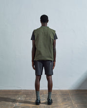 Full-length rear view of #3029, coriander-coloured organic canvas vest.