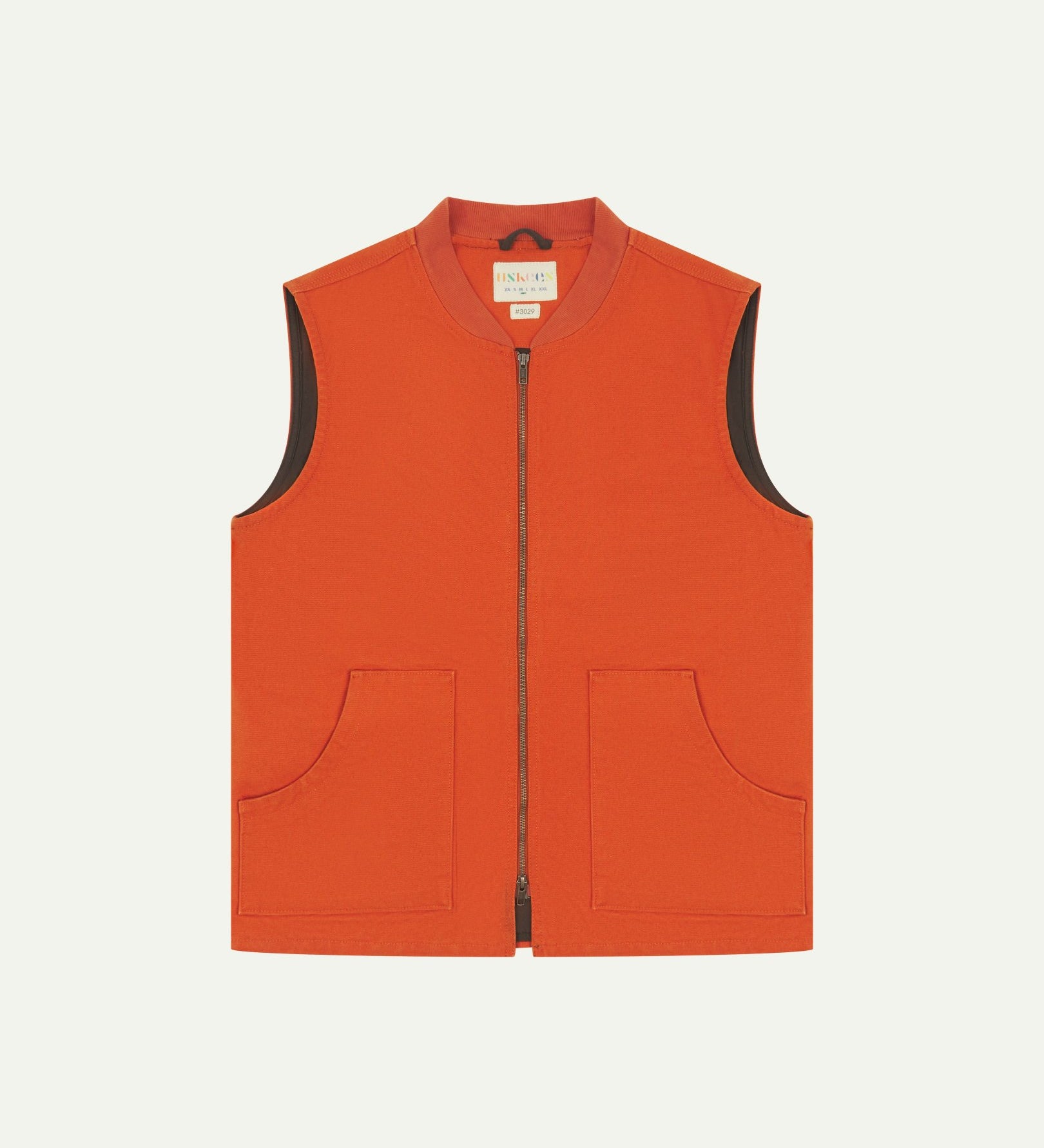 Front flat shot of golden-orange gilet-type zip front waistcoat showing the front patch pockets, contrasting lining and Uskees brand label at neck.