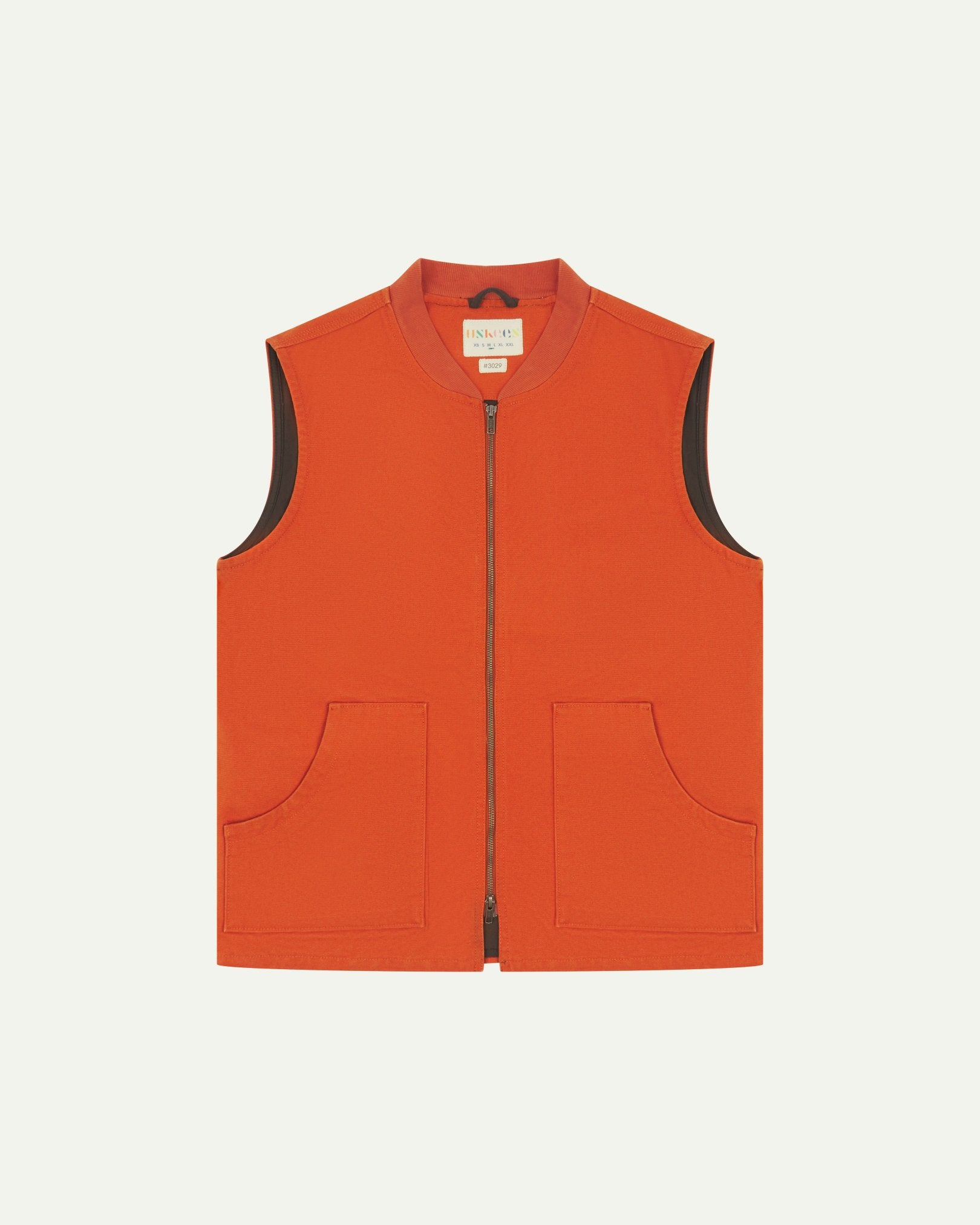 Front flat shot of golden-orange gilet-type zip front waistcoat showing the front patch pockets, contrasting lining and Uskees brand label at neck.