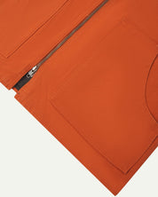 Front flat close-up shot of Uskees golden-orange zip front vest-waistcoat showing the front cut-away patch pockets and double-ended zip.