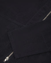 Angled close-up flat view of the pocket detailing of #5030 Uskees midnight blue jacket. View of wide, diagonal cut pockets, reinforced elbows and cuffs.