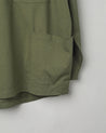 Close-up, bottom-right view of #3032 army green smock from Uskees showing large hip pocket.