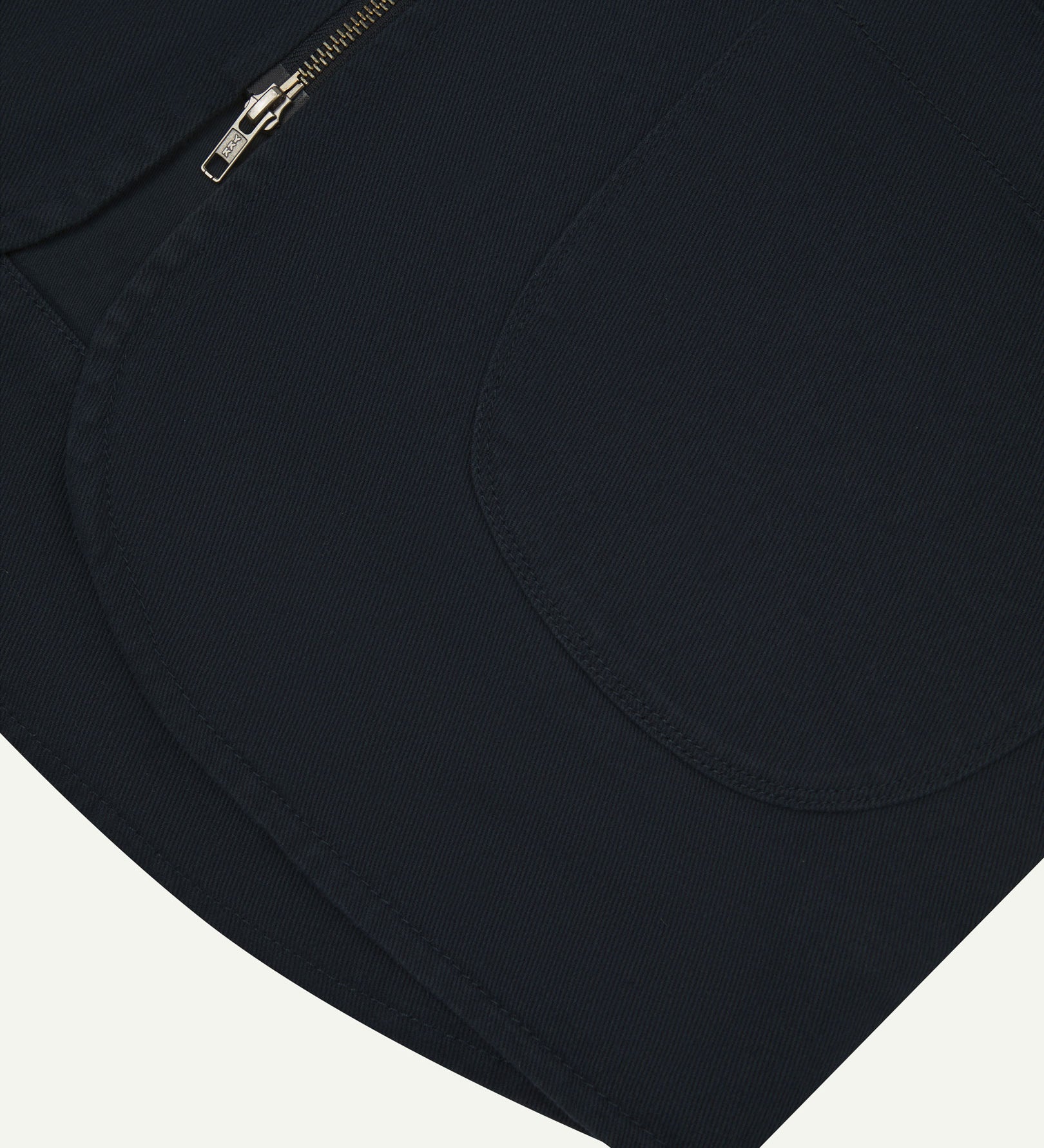 Close-up bottom-half view of #3036 dark blue (blueberry) organic cotton-drill vest with focus on curved pocket detail.
