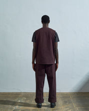 Full-length rear view of #3036, dark plum organic cotton-drill vest from Uskees.