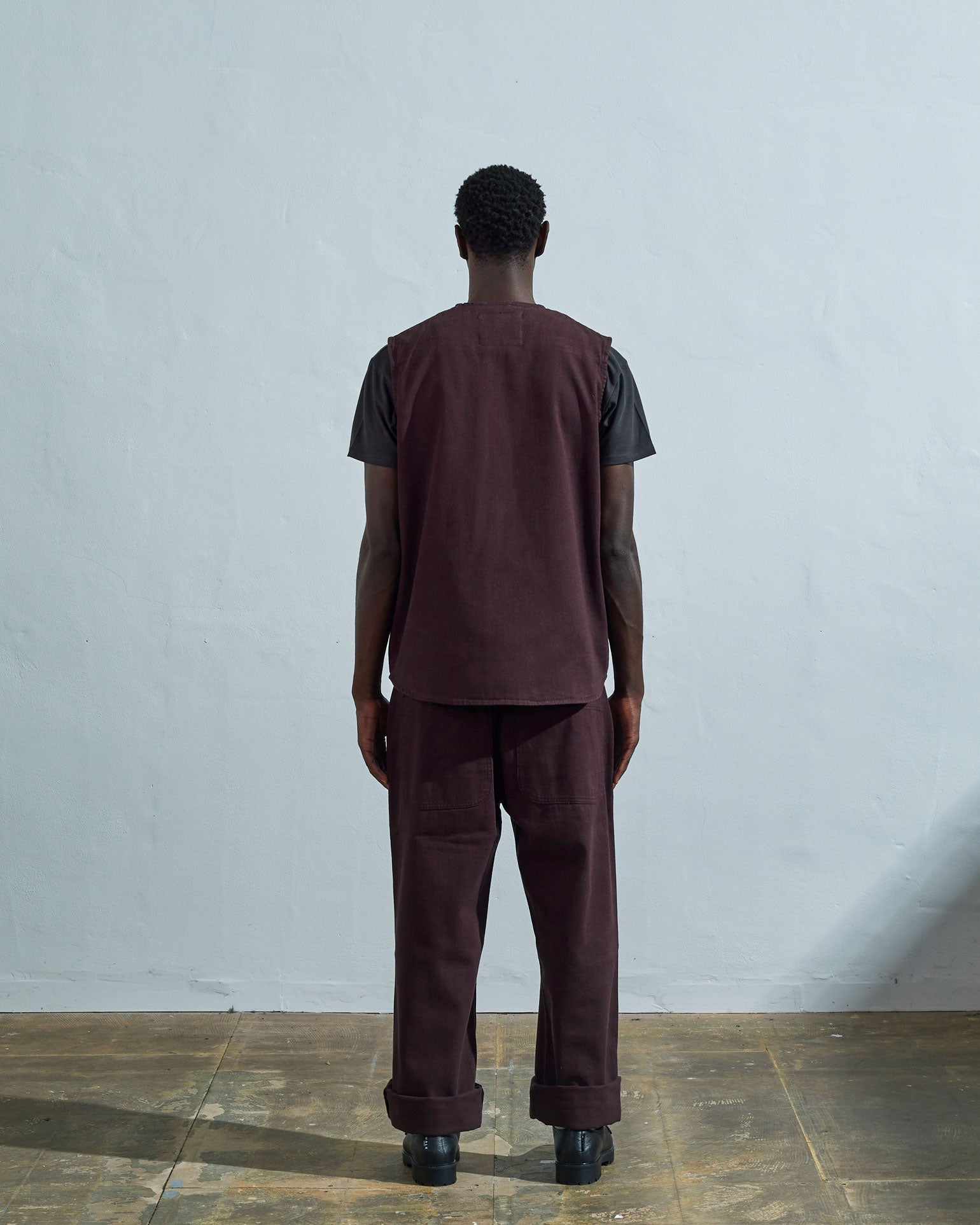 Full-length rear view of #3036, dark plum organic cotton-drill vest from Uskees.