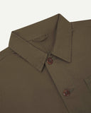 Neck view of Uskees 3040 dark taupe herringbone cotton engineer jacket with focus on collar and matching corozo buttons.
