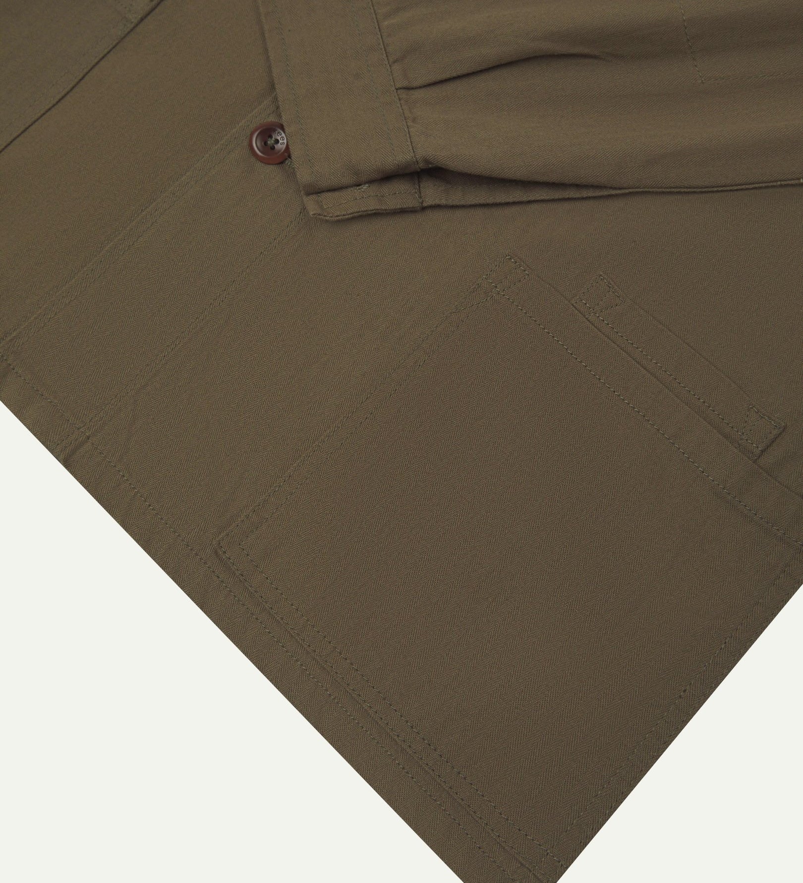 Sleeve view of Uskees 3040 dark taupe herringbone cotton engineer jacket with focus on placket, buttoned cuff and ticket pocket.