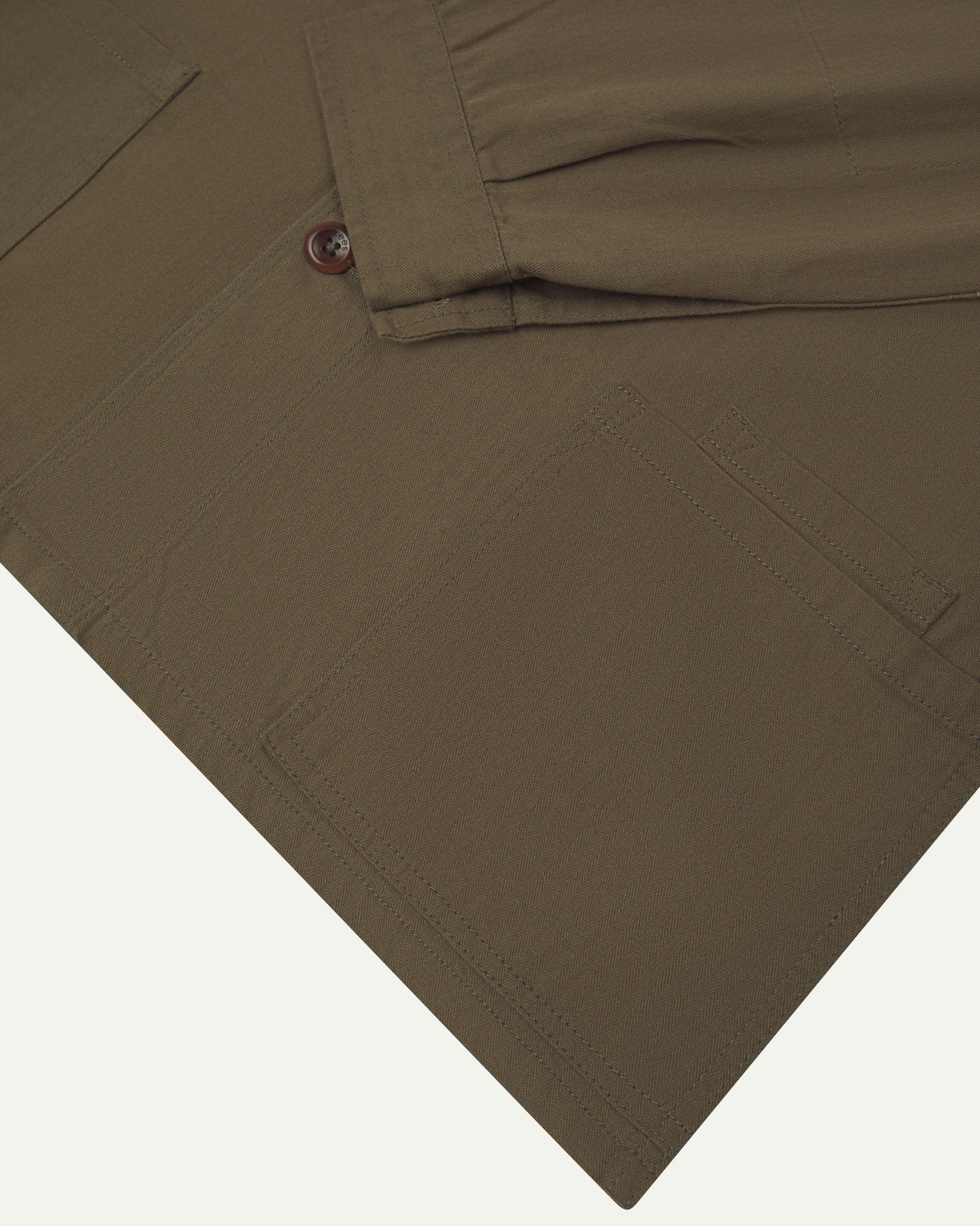 Sleeve view of Uskees 3040 dark taupe herringbone cotton engineer jacket with focus on placket, buttoned cuff and ticket pocket.