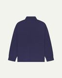 Full back view of Uskees deep indigo organic herringbone cotton engineer jacket showing reinforced elbows and simple lines.