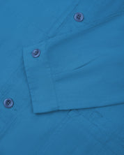 Sleeve view of Uskees 3040 opal-blue herringbone cotton engineer jacket with focus on placket, buttoned cuff and ticket pocket.