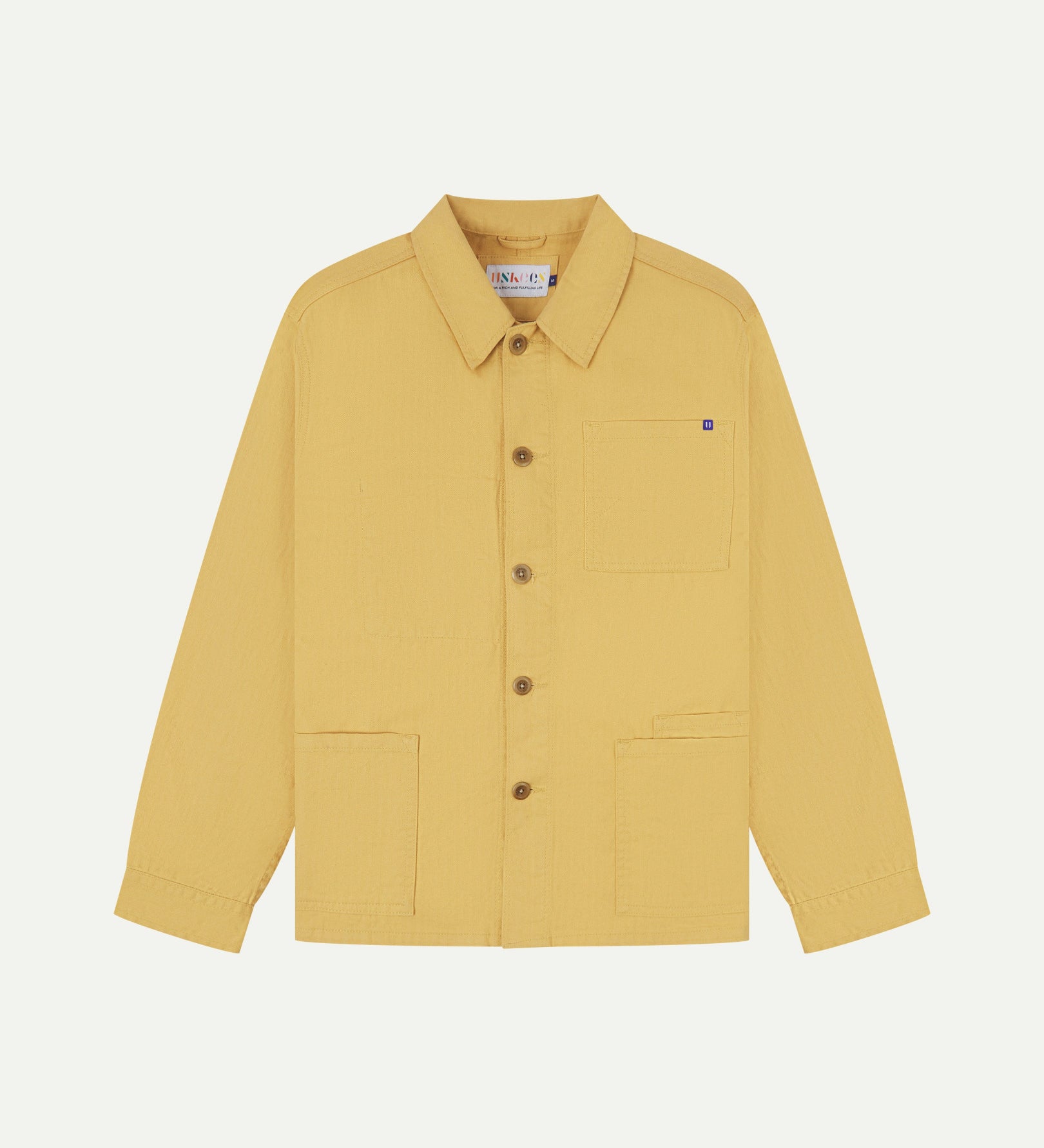 Full front view of Uskees sandstone-yellow organic herringbone cotton engineer jacket with 2 deep hip pockets with internal ticket pocket and chest pocket.