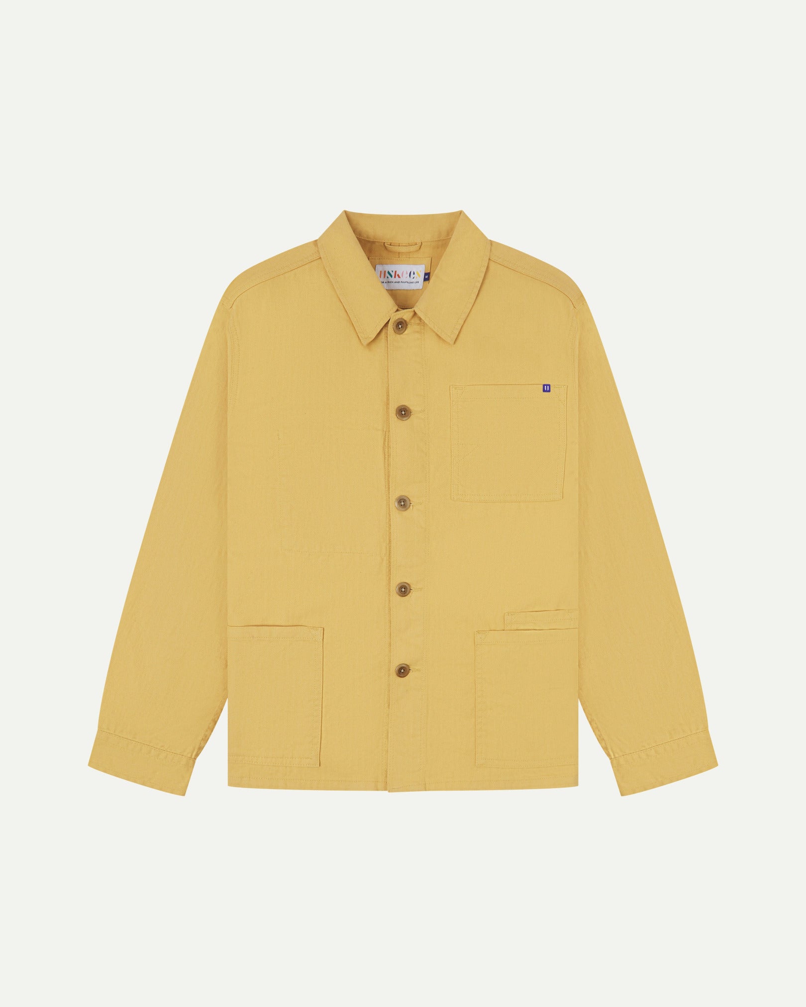 Full front view of Uskees sandstone-yellow organic herringbone cotton engineer jacket with 2 deep hip pockets with internal ticket pocket and chest pocket.