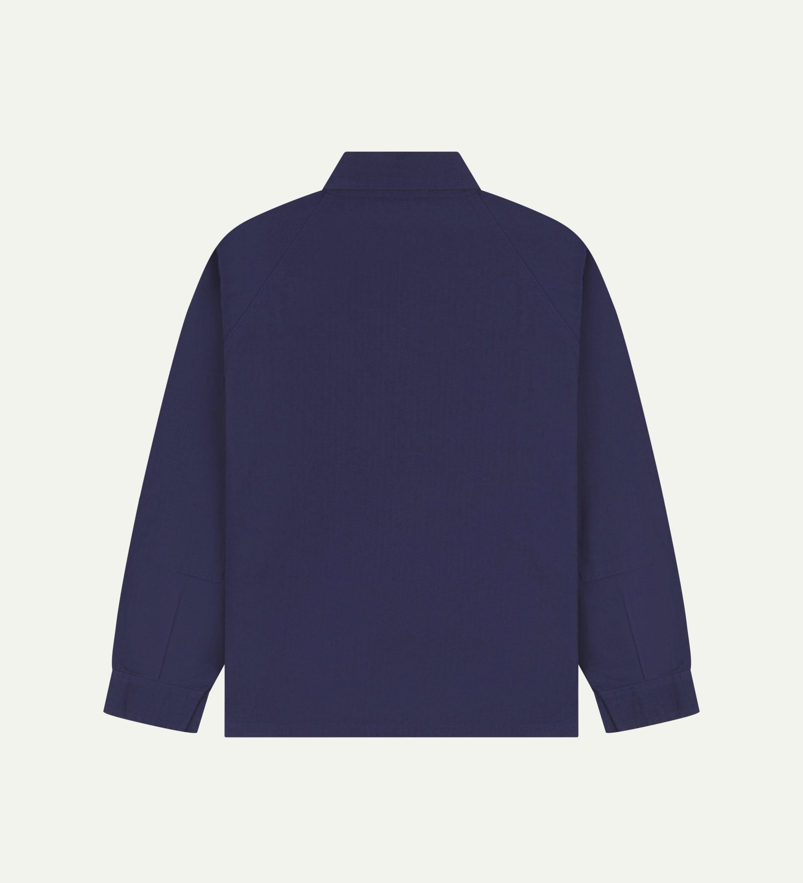 Flat back view of organic cotton deep indigo signal jacket from Uskees with view of reinforced elbows and raglan sleeves.