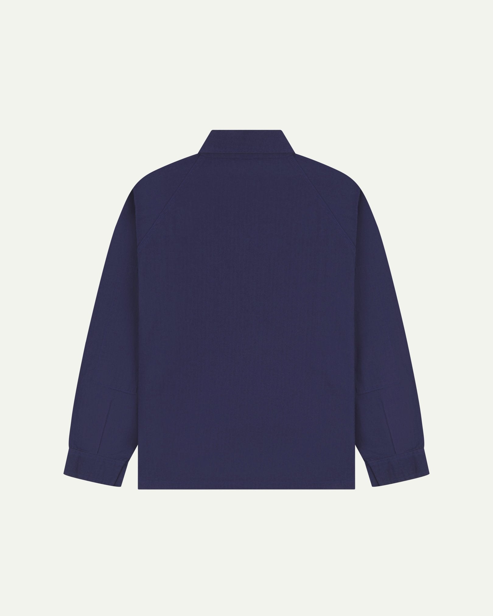 Flat back view of organic cotton deep indigo signal jacket from Uskees with view of reinforced elbows and raglan sleeves.