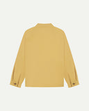 Flat back view of organic cotton sandstone-yellow signal jacket from Uskees with view of reinforced elbows and raglan sleeves.