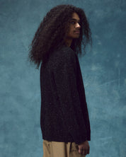 Top-half view of man wearing the #3043 hip-length knitted organic cotton cardigan in black.