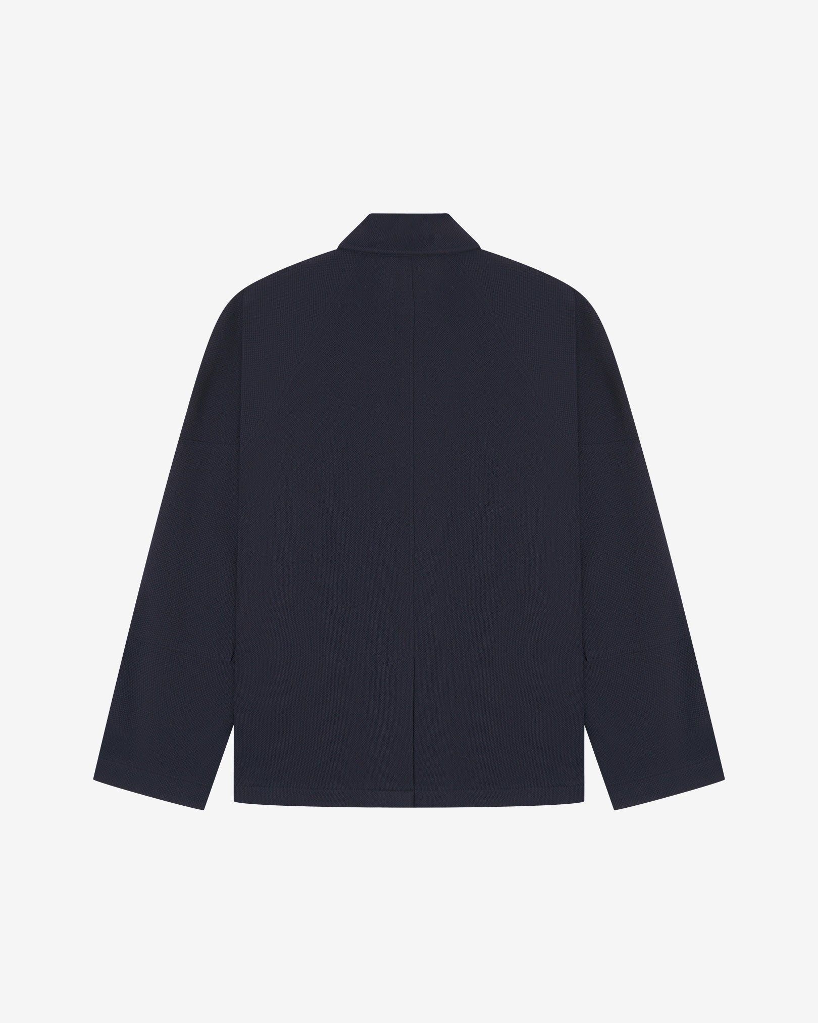 Flat back view of knitted organic cotton midnight blue blazer from Uskees with view of vent and reinforced elbows.