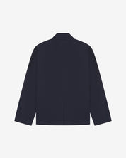 Flat back view of knitted organic cotton midnight blue blazer from Uskees with view of vent and reinforced elbows.