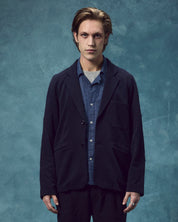 Front view of man wearing the #3044 knitted blazer in midnight blue. Jacket open, emphasising the looser, informal fit.