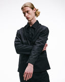 Person wearing an Uskees ripstop black zip front jacket and matching trousers on a white background.