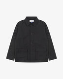 Front view of Uskees black ripstop utility jacket showing the chest zip pocket and two gusseted hip pockets with flaps.