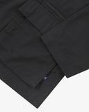 Close up view of Uskees black ripstop utility jacket with focus on a hip pockets, zip pocket and reinforced elbows.