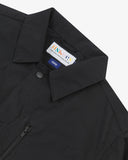 Close up view of Uskees black ripstop utility jacket with focus on the collar, popper button and branding label.