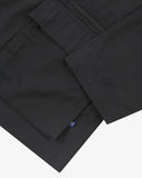 Close up view of Uskees black ripstop utility jacket with focus on a hip pockets, zip pocket and reinforced elbows.