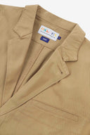 Close-up and angled front view of the 3047 docklands blazer showing the twill fabric texture, collar, lapel, Uskees branding label and jetted breast pocket.