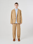 Front view of male model wearing the Uskees 3047 Docklands khaki blazer unbuttoned, paired with matching Uskees pants.