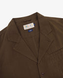 Close-up and angled front view of the 3047 docklands blazer showing the linen fabric texture, collar, lapel, Uskees branding label and jetted breast pocket.