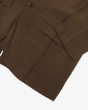 Close-up view of the cuff, jetted hip pocket with flap and corozo buttons of the 3047 docklands blazer from Uskees. Also is a closer view of the texture of the brown linen blend fabric. 