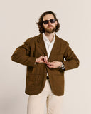 Three-quarter pose of man wearing the Uskees 3047 Docklands brown blazer, paired with a white shirt.