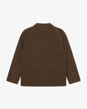 Back view flat shot of an Uskees brown linen blazer for men showing the brand label and Corozo buttons.