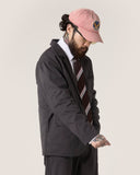 3/4 view of a bearded male model wearing the Uskees charcoal docklands blazer, matching trousers and a white shirt.