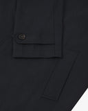 Front close up shot of an Uskees midnight blue car coat sleeve and cuff on a light gray background