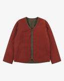 Front view of Uskees Evo liner jacket reversed showing the orange-red reversable lining and the chest and twin wax welt pockets.