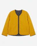 Front view of Uskees Evo liner jacket reversed showing the bright yellow reversable lining and the chest and twin welt pockets.