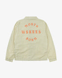 Back view flat shot of Uskees pastel yellow check coach jacket for men with focus on the the North Born Uskees slogan, straight-cut hem and elasticated cuffs.