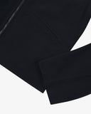 Close up view of an Uskees zip up bomber jacket for men in dark blue showing the cuff and zipper detail.