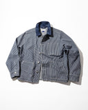 Front view of an Uskees blue and white striped canvas utility jacket with a solid navy blue corduroy collar, laid flat against a white background.