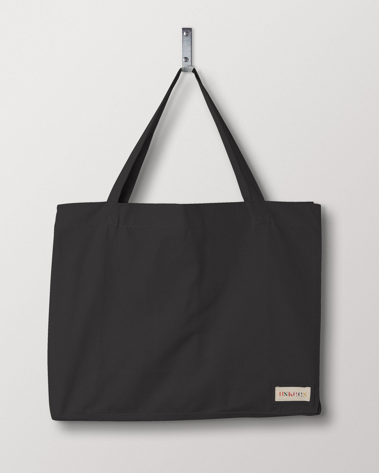 Full front hanging shot of Uskees #4001 large charcoal tote bag, showing double handles and Uskees woven logo.