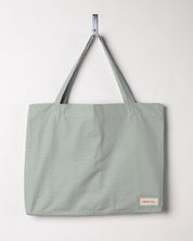 Full front hanging shot of Uskees #4001, large jade tote bag, showing double handles and Uskees woven logo.