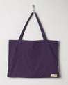 Full front hanging shot of Uskees #4001, large purple tote bag, showing double handles and Uskees woven logo.