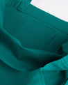 Close-up inside view of Uskees #4002 small tote bag in foam green with focus on the small internal pocket.
