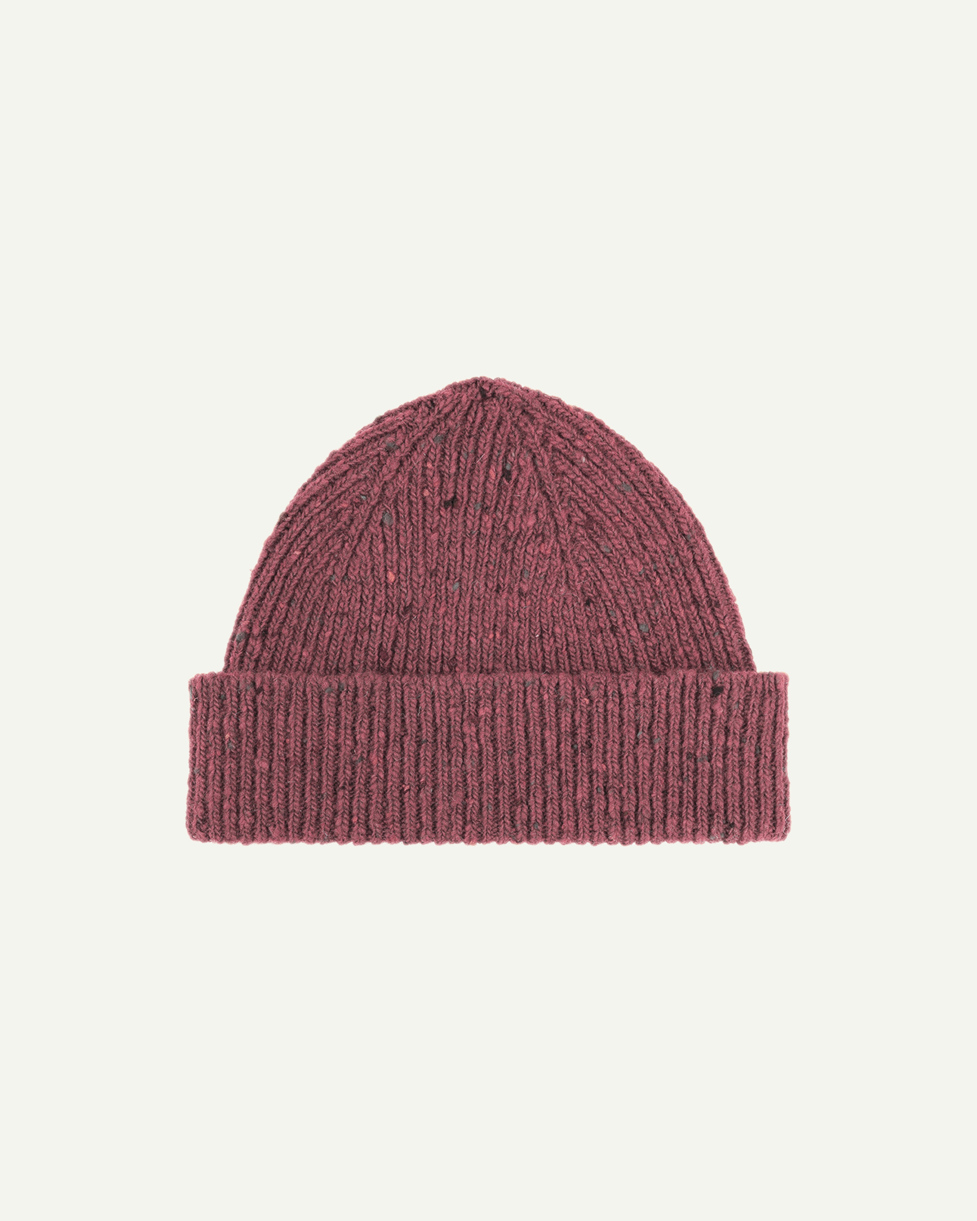  Flat view of Uskees 4003 donegal wool hat in 'dusty pink' . There is a clear view of the adjustable cuff and the 'speckled' nature of the hat.