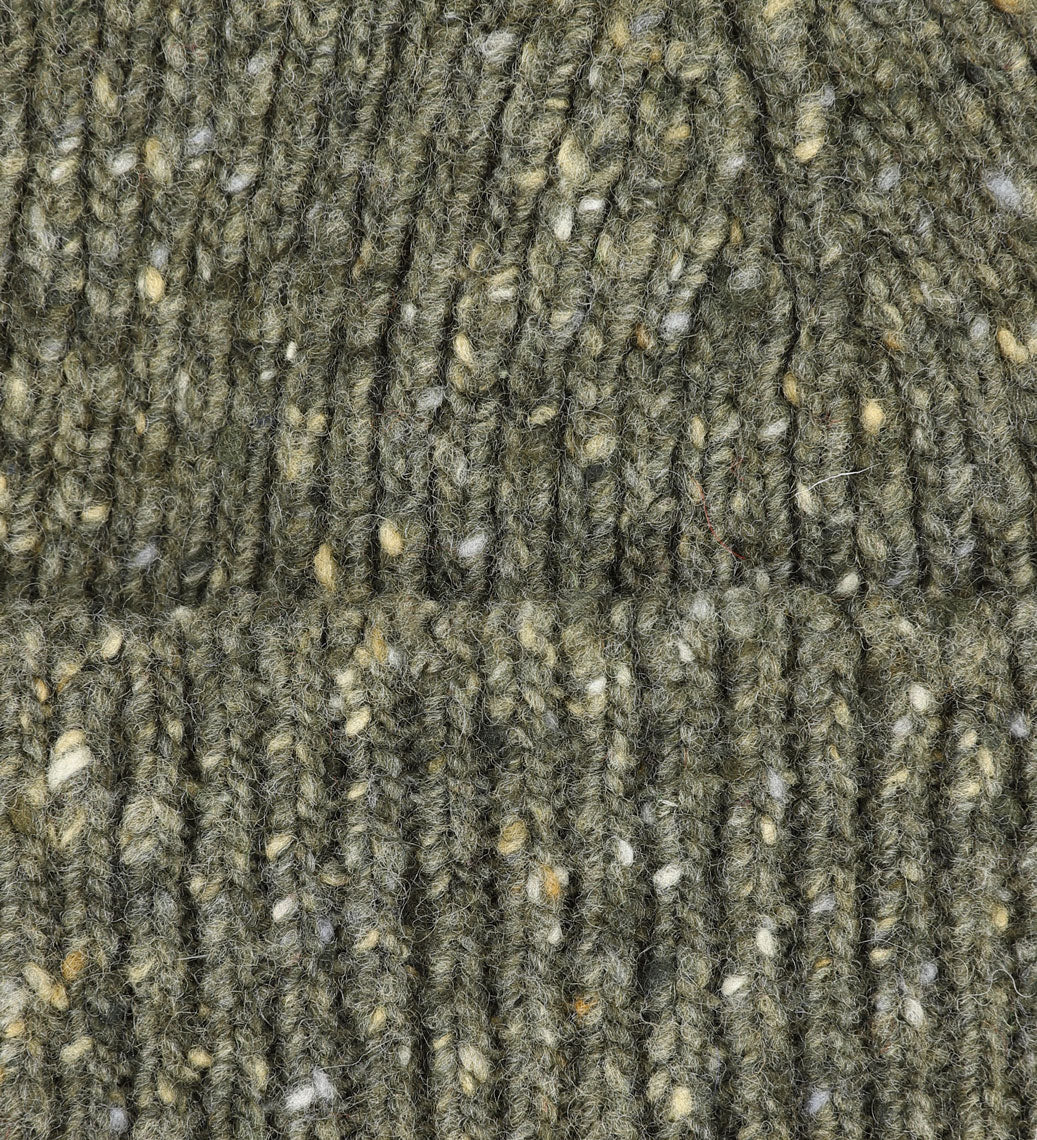 Close-up view of Uskees 4003 'army green' speckled donegal wool hat, showing the texture of the natural Scottish merino wool.