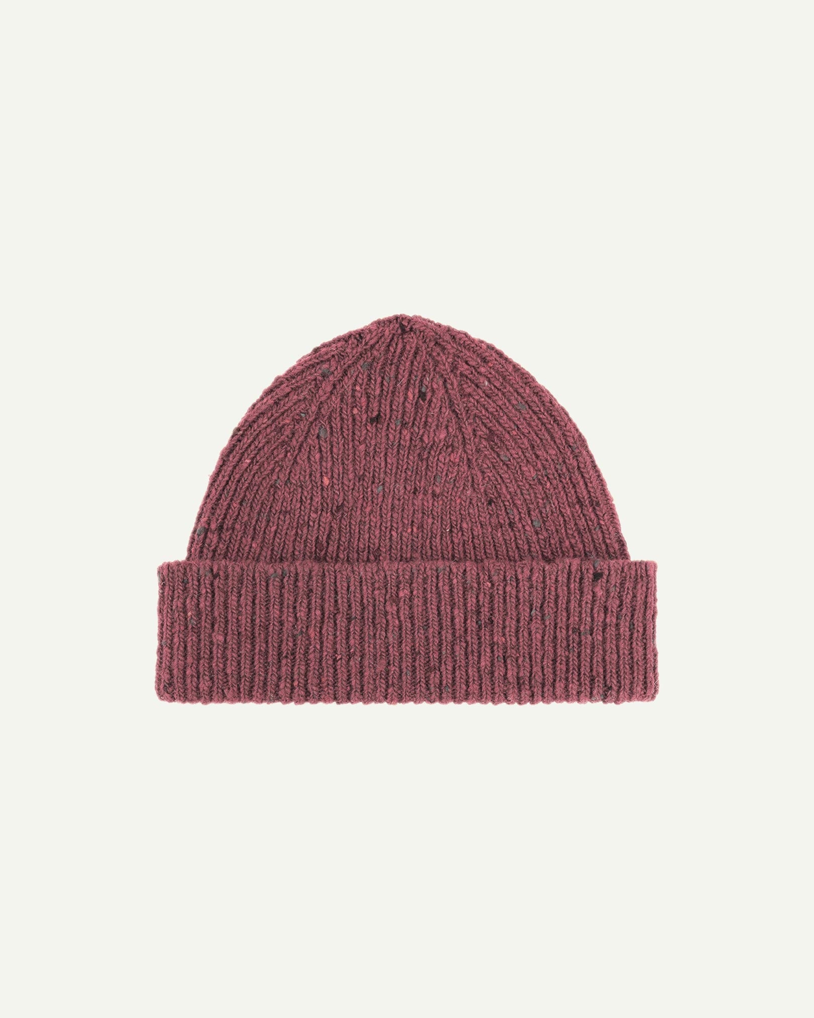 Flat view of Uskees 4003 donegal wool hat in 'dusty pink' . There is a clear view of the adjustable cuff and the 'speckled' nature of the hat.